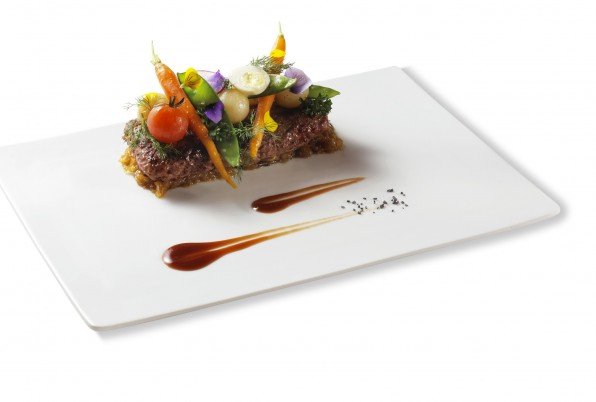 La nostra hamburguesa de filet Angus farcida de foie, essència de tartufo, ceba tractada, jardí de verduretes i tocs fumats a brasa.