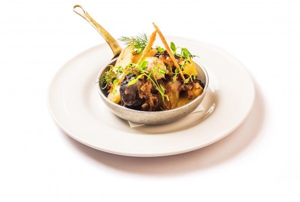 Skillet of crispy and juicy onion blood sausage, applesauce, caramelised onion, crispy parmesan and caramelised goat bonbons.