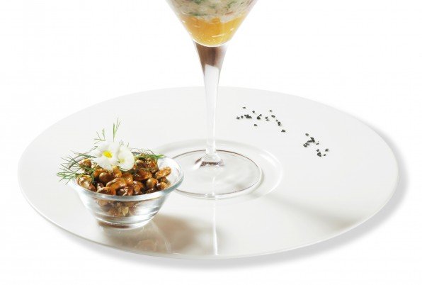 Corvina tratada como un ceviche, rocoto, limón de pica, fino puré de camote asado y crujiente de cancha servido como un Martini!!!.